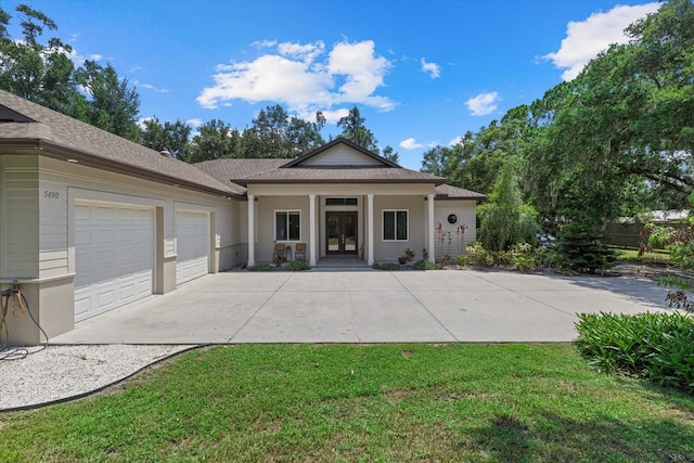 back of property with a yard and a garage