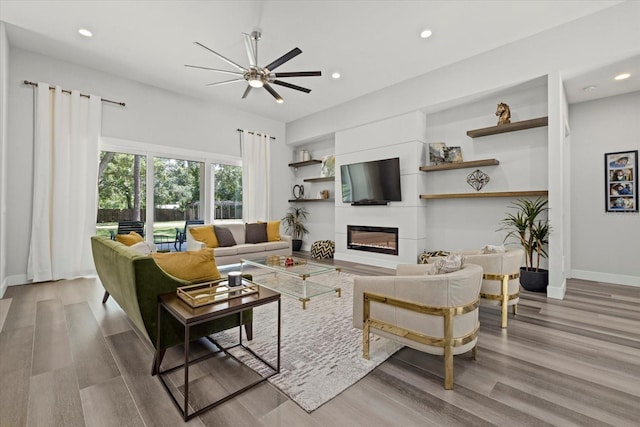 living room featuring light hardwood / wood-style flooring and ceiling fan