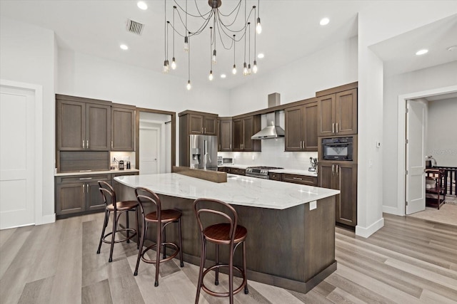 kitchen with light wood-type flooring, pendant lighting, and a center island