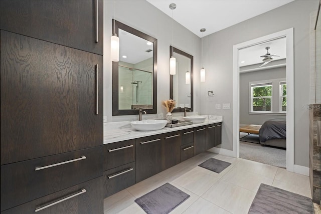 bathroom featuring a shower with door, vanity, ceiling fan, and tile patterned floors