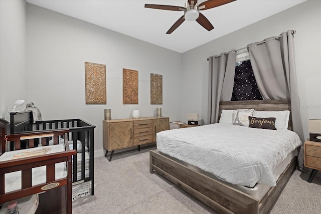 bedroom featuring light carpet and ceiling fan