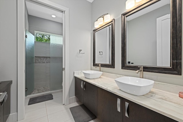 bathroom featuring a shower with shower door, tile patterned flooring, and vanity