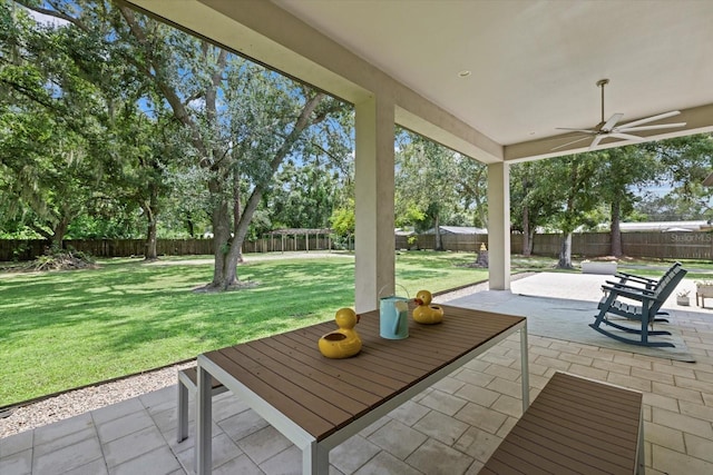 unfurnished sunroom with ceiling fan