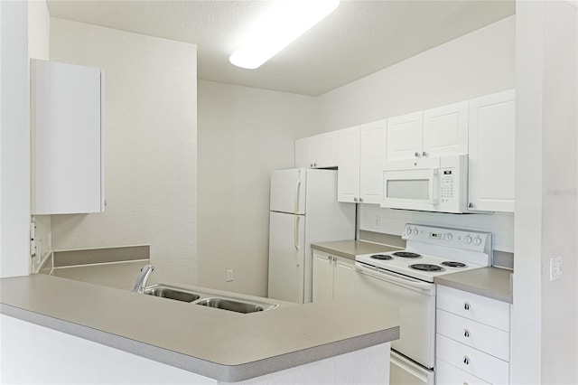 kitchen with white appliances, white cabinets, sink, backsplash, and kitchen peninsula