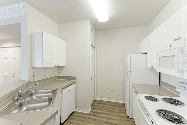 kitchen with white cabinets, sink, light hardwood / wood-style flooring, and white appliances