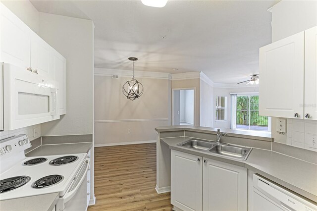 kitchen with ceiling fan with notable chandelier, white appliances, tasteful backsplash, white cabinetry, and light hardwood / wood-style flooring