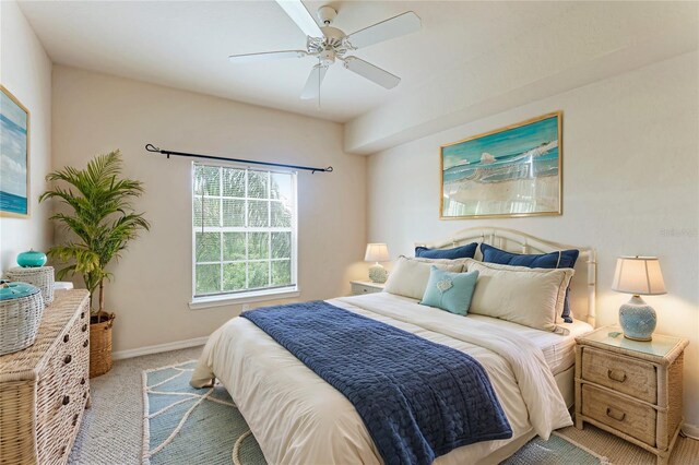 bedroom with baseboards, a ceiling fan, and light colored carpet