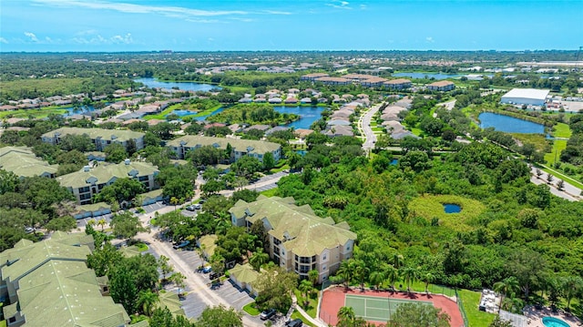 drone / aerial view featuring a water view and a residential view