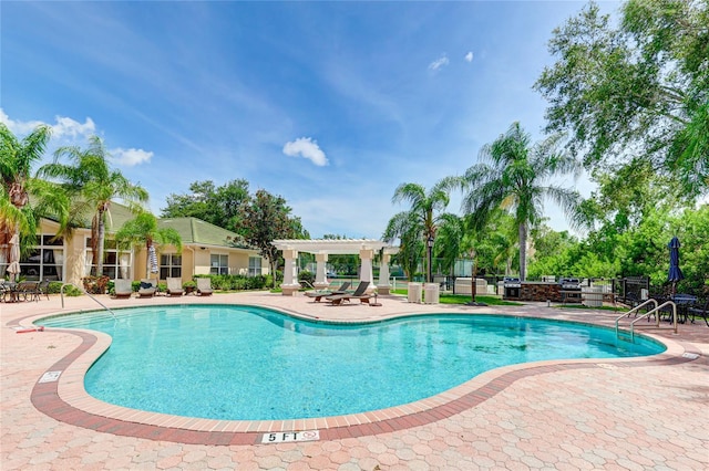 pool featuring a patio, fence, and a pergola