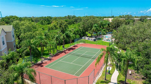 view of tennis court featuring fence