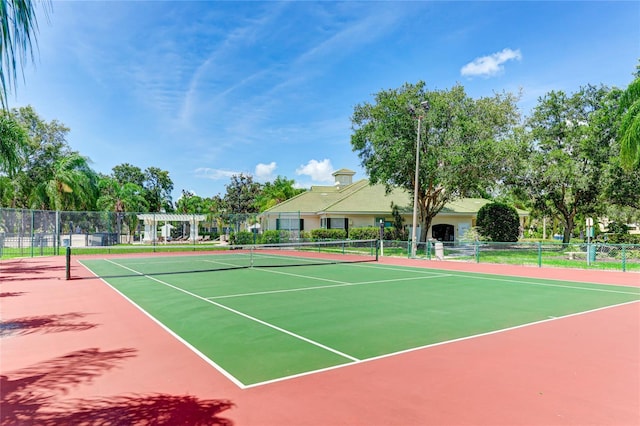 view of sport court featuring fence and a pergola