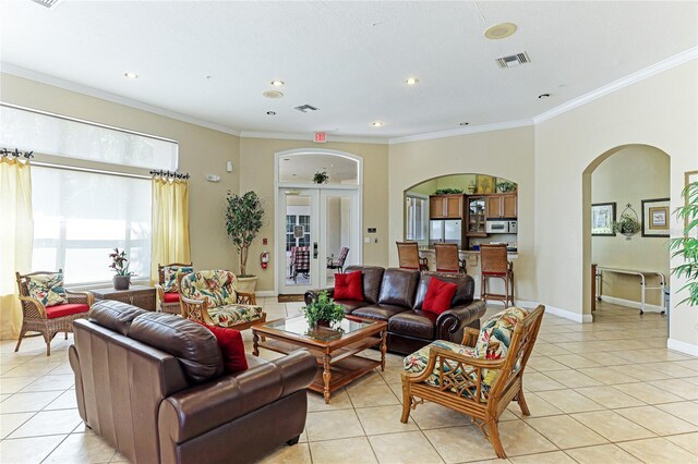 living room with ornamental molding and light tile patterned floors