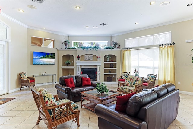 living room with light tile patterned floors, a fireplace, visible vents, baseboards, and crown molding