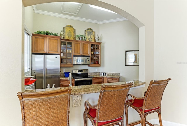 kitchen with a breakfast bar and appliances with stainless steel finishes