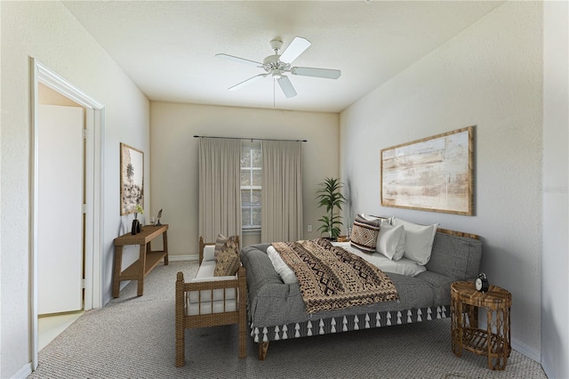 bedroom with baseboards, a ceiling fan, and light colored carpet