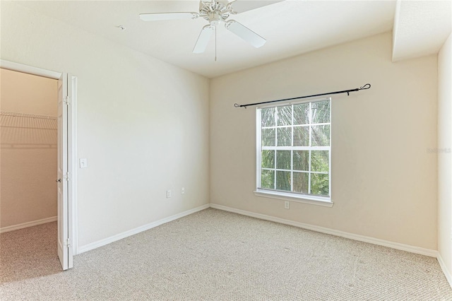 spare room featuring ceiling fan and carpet floors