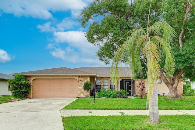 view of front of property with a garage and a front lawn