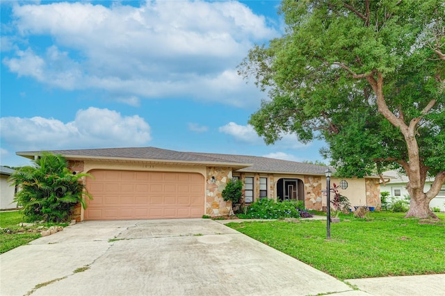 single story home featuring a garage and a front yard