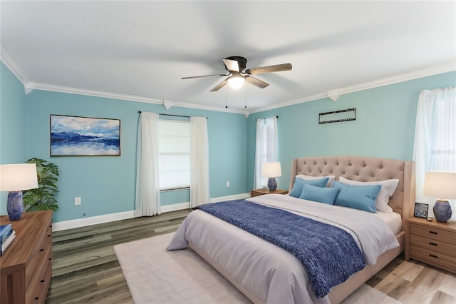 bedroom with ceiling fan, hardwood / wood-style flooring, and crown molding