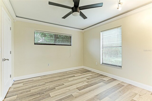 spare room featuring crown molding, ceiling fan, and light hardwood / wood-style floors