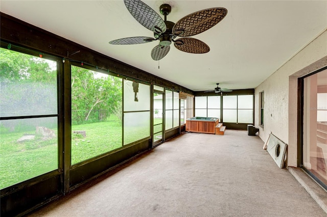 unfurnished sunroom featuring a healthy amount of sunlight and ceiling fan