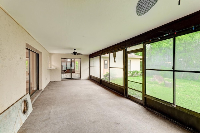 unfurnished sunroom with a healthy amount of sunlight and ceiling fan