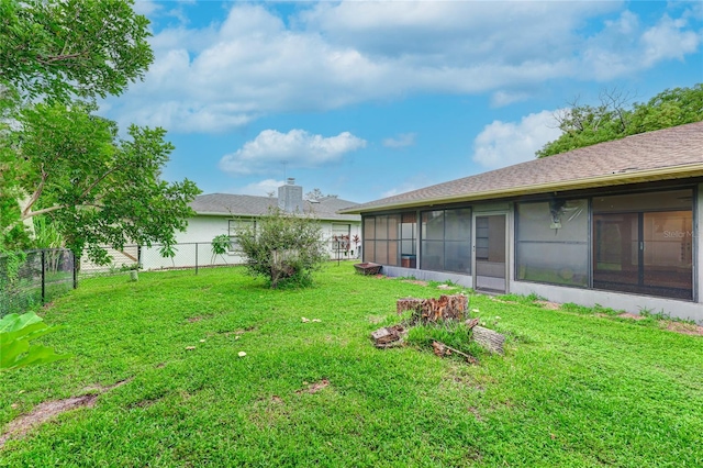 view of yard with a fenced backyard and a sunroom