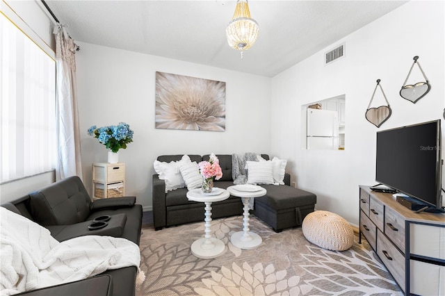 living room featuring a notable chandelier and plenty of natural light