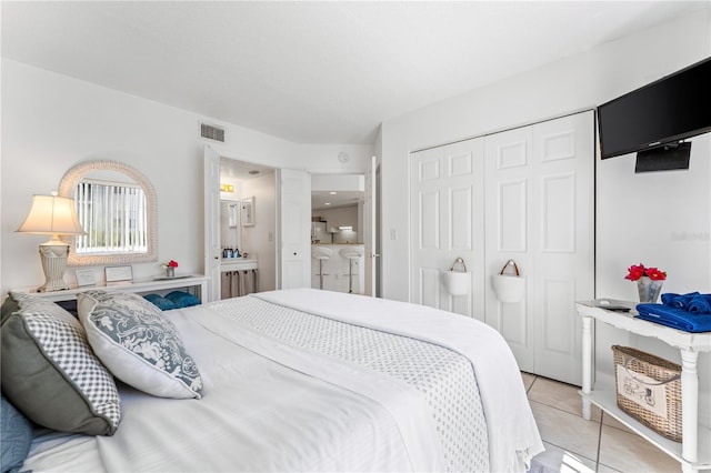 bedroom with a closet and light tile patterned floors