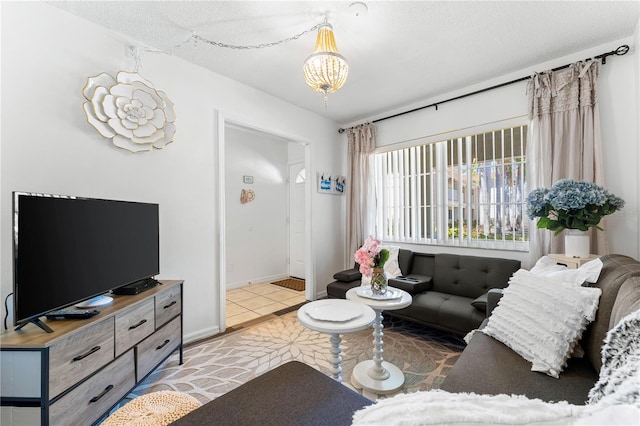 tiled living room with a chandelier and a textured ceiling