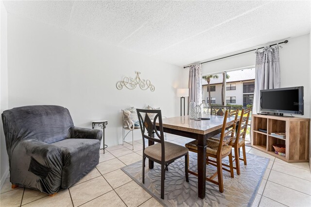 dining area with light tile patterned flooring and a textured ceiling