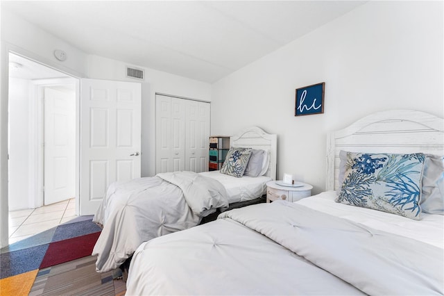 bedroom featuring a closet and light tile patterned floors