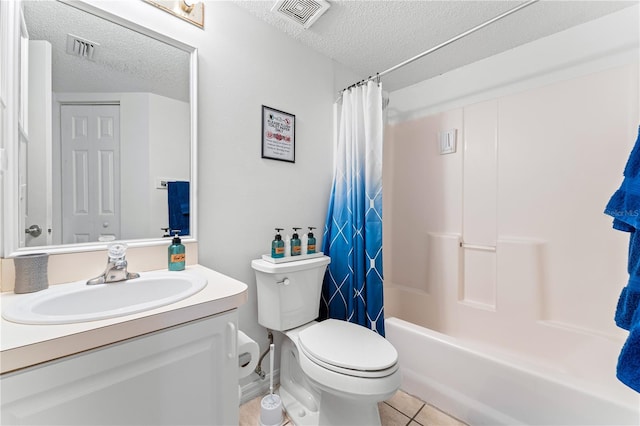 full bathroom with vanity, shower / bath combo with shower curtain, toilet, a textured ceiling, and tile patterned flooring