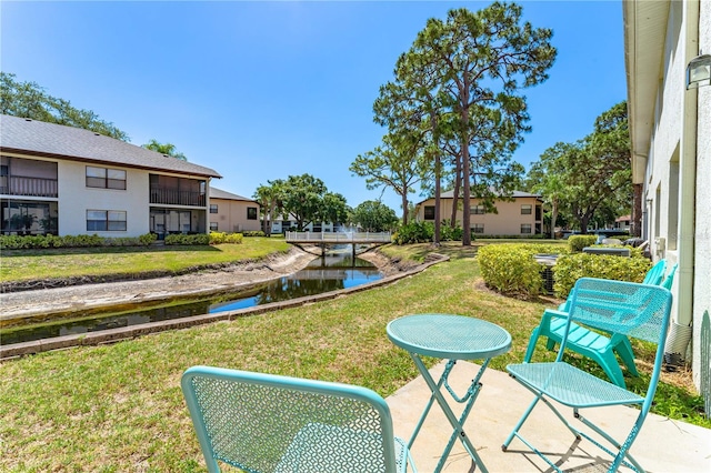 exterior space featuring a balcony and a water view