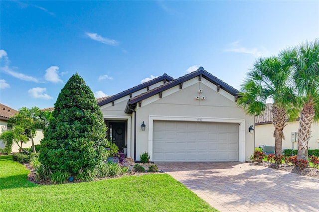 view of front of house with a front yard and a garage