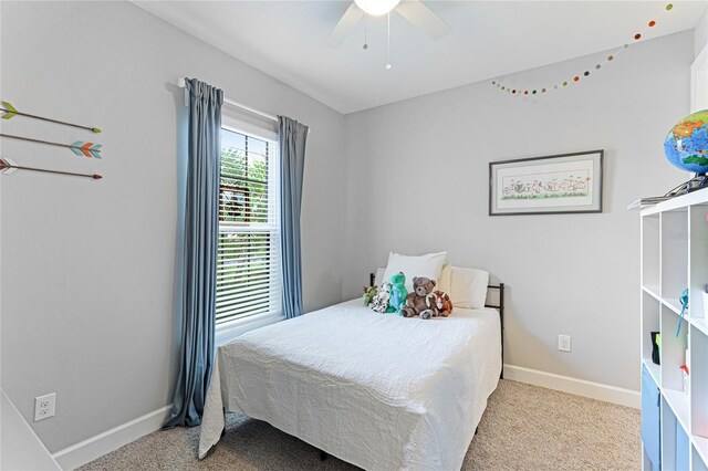 bedroom featuring light colored carpet and ceiling fan