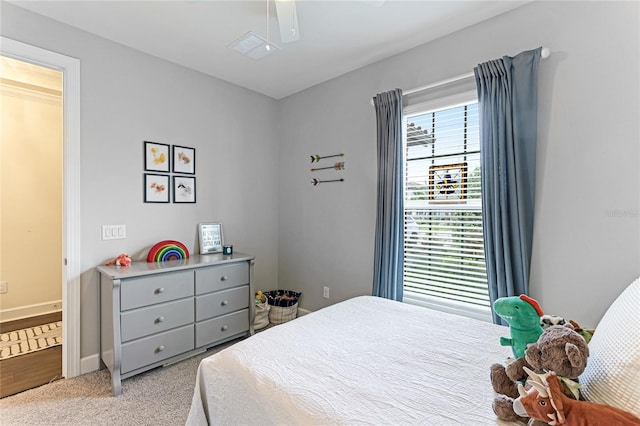 bedroom with ceiling fan and light carpet