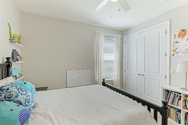 bedroom featuring ceiling fan and a closet