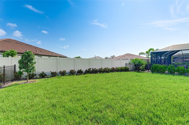 view of yard with glass enclosure