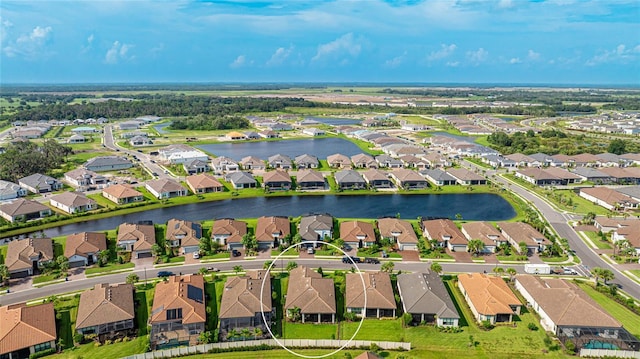 birds eye view of property with a water view