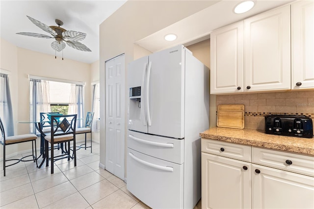 kitchen with ceiling fan, white refrigerator with ice dispenser, tasteful backsplash, and white cabinets