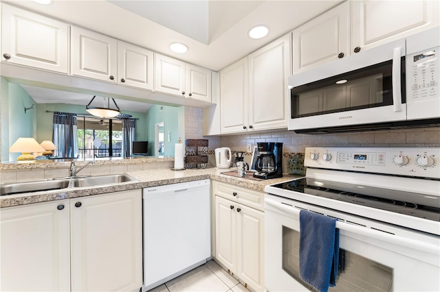 kitchen with white cabinetry, white appliances, light tile patterned floors, backsplash, and sink