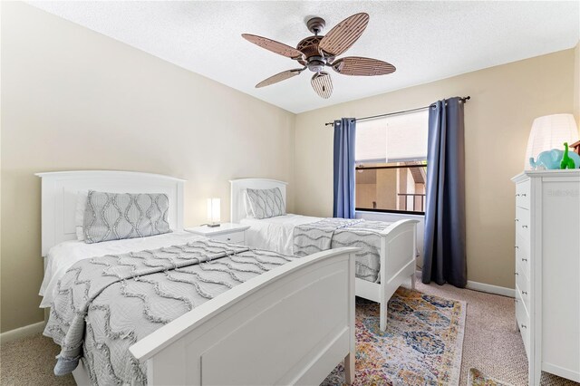 carpeted bedroom with a textured ceiling and ceiling fan