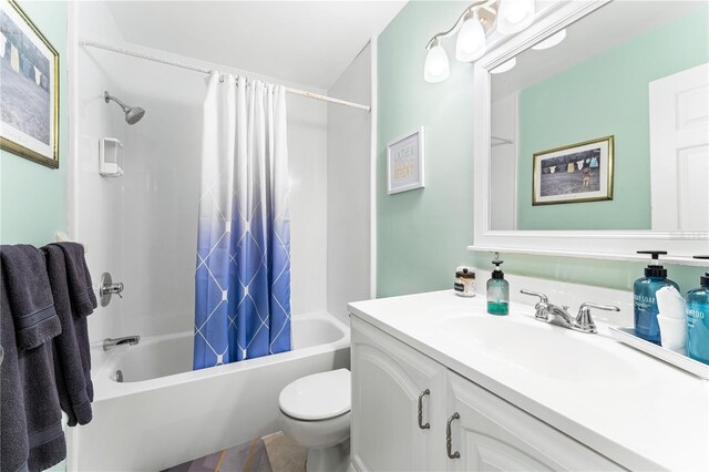 full bathroom featuring shower / bath combo with shower curtain, toilet, and vanity