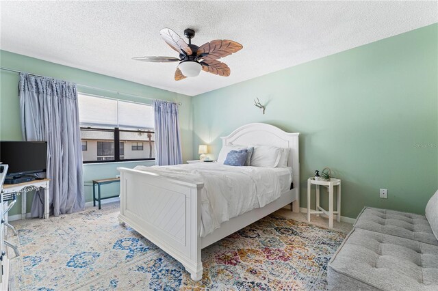 carpeted bedroom with a textured ceiling and ceiling fan