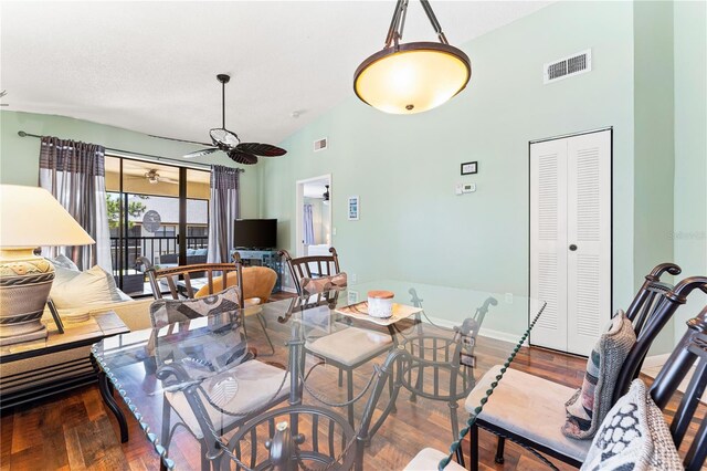 dining area with high vaulted ceiling, ceiling fan, and hardwood / wood-style floors