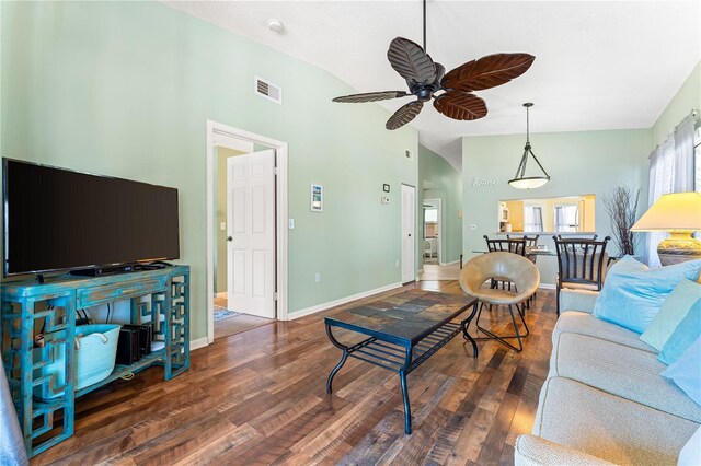 living room featuring ceiling fan, high vaulted ceiling, and dark wood-type flooring