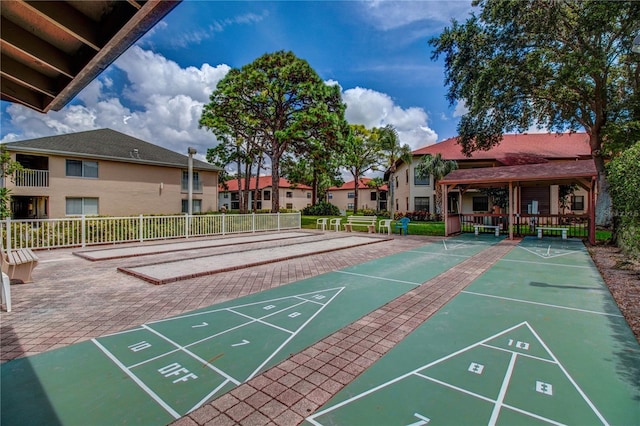 view of home's community featuring shuffleboard