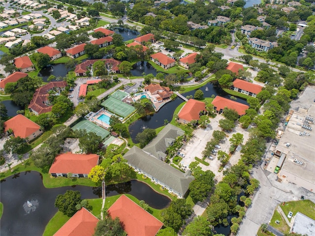 birds eye view of property with a water view and a residential view