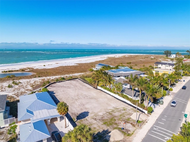 drone / aerial view featuring a water view and a beach view